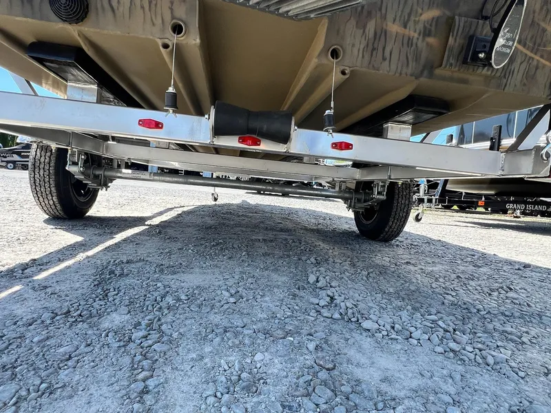 Slide: The Image of Underneath view of a 2025 G3 Gator Tough 18 CCJ boat trailer on gravel. - 8
