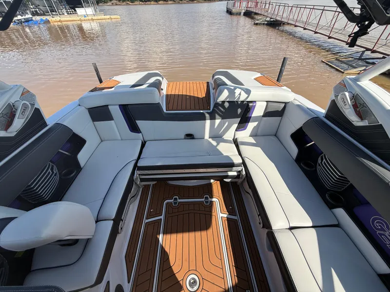 Slide: The Image of Interior of 2014 Nautique Super Air Nautique G21 boat with luxurious seating and wood flooring. - 13