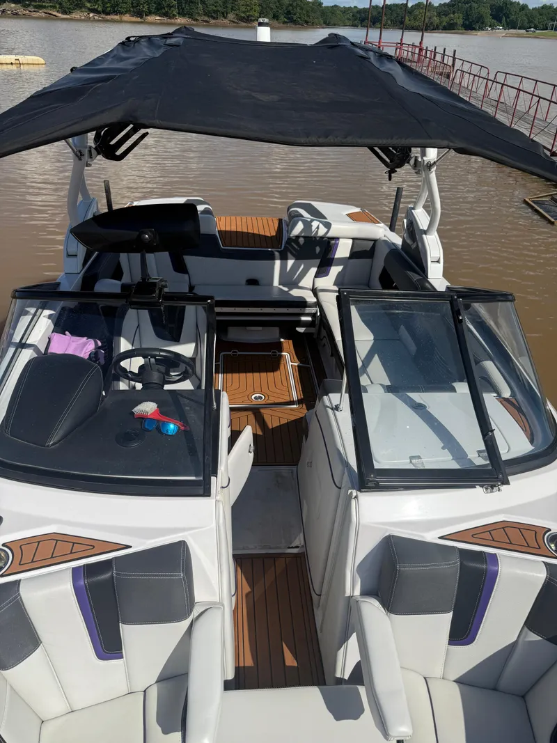 Slide: The Image of 2014 Nautique Super Air Nautique G21 boat with canopy on a calm lake. - 14