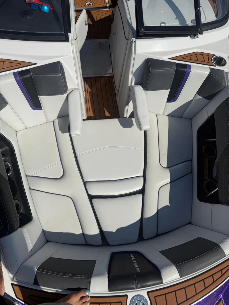 Slide: The Image of 2014 Nautique Super Air Nautique G21 boat interior with white and black seating. - 16