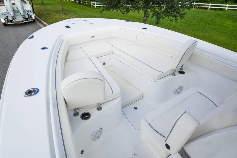 Slide: The Image of 2025 Sea Hunt Gamefish 28 FS boat interior with white seating and sleek design. - 11