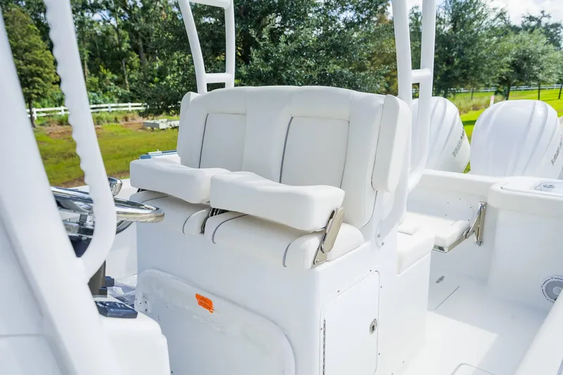 Slide: The Image of 2025 Sea Hunt Gamefish 28 FS boat interior with white seating and dual engines. - 17