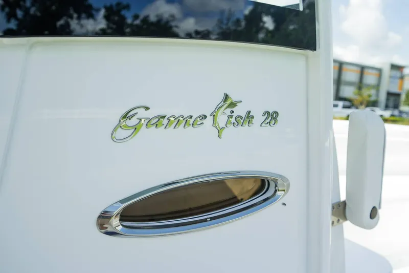 Slide: The Image of 2025 Sea Hunt Gamefish 28 FS boat logo on white surface. - 18