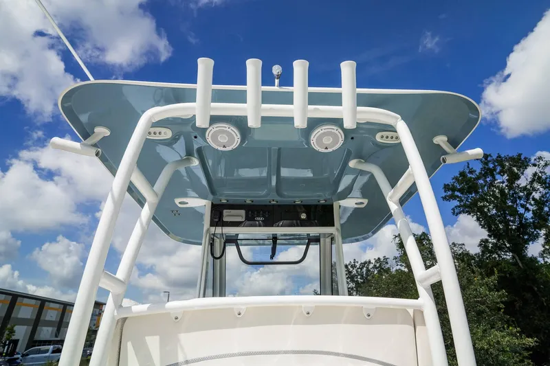 Slide: The Image of 2025 Sea Hunt Gamefish 28 FS boat, T-top view against blue sky. - 21