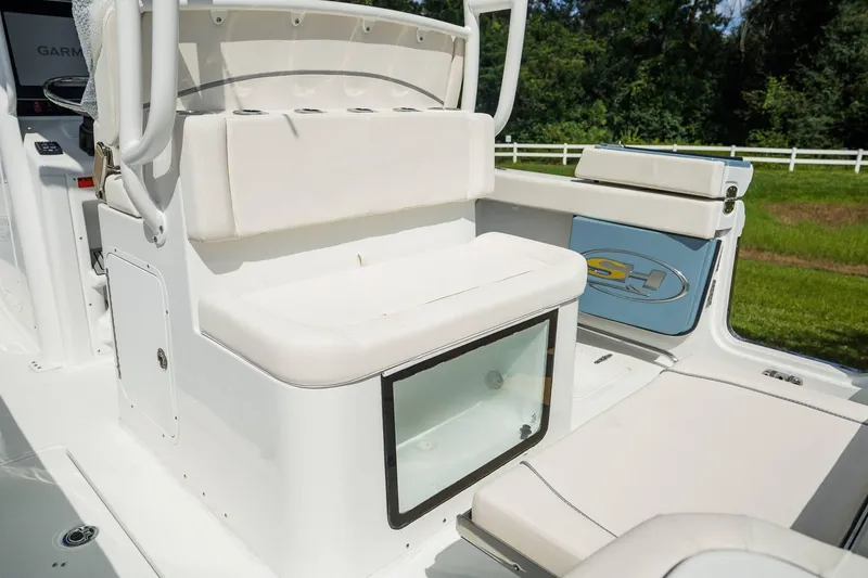 Slide: The Image of 2025 Sea Hunt Gamefish 28 FS boat interior with cushioned seating and storage. - 22