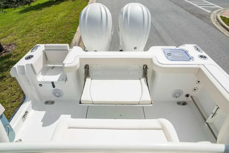 Slide: The Image of 2025 Sea Hunt Gamefish 28 FS boat interior with dual engines and seating area. - 24