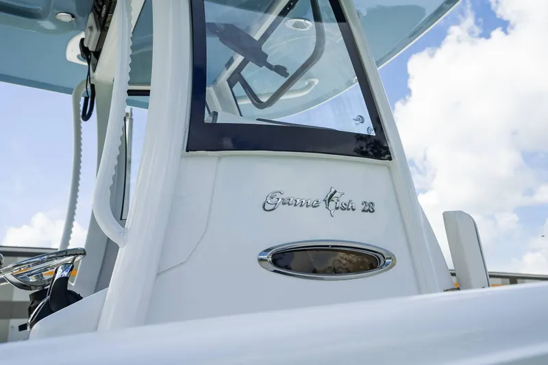 Slide: The Image of 2025 Sea Hunt Gamefish 28 FS boat console with clear sky background. - 29