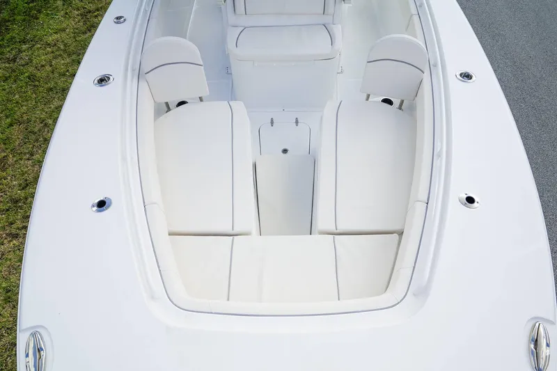 Slide: The Image of 2025 Sea Hunt Gamefish 28 FS boat interior with white cushioned seating. - 9