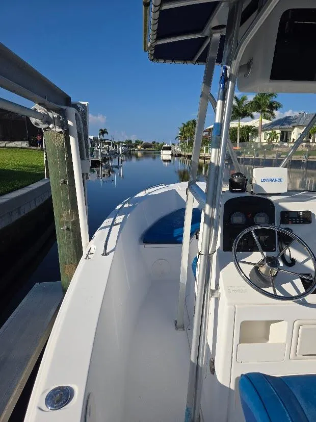 Slide: The Image of 2008 Sea Hunt Triton 220 boat docked on a sunny canal. - 10