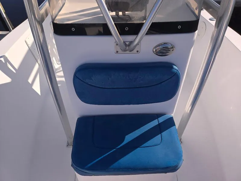 Slide: The Image of 2008 Sea Hunt Triton 220 boat seat with blue cushions and stainless steel frame. - 13
