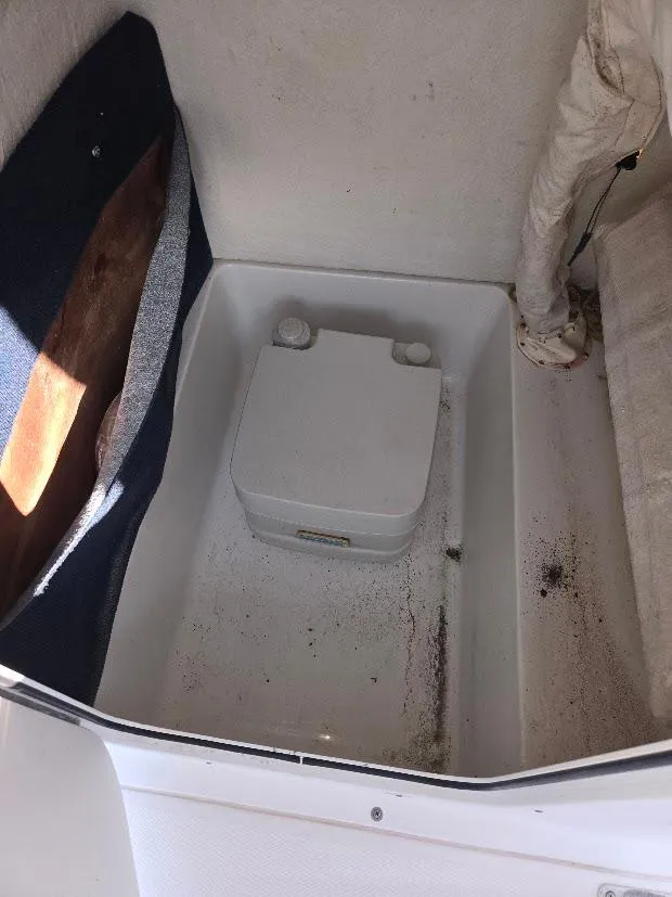 Slide: The Image of 2008 Sea Hunt Triton 220 boat interior with portable toilet. - 14