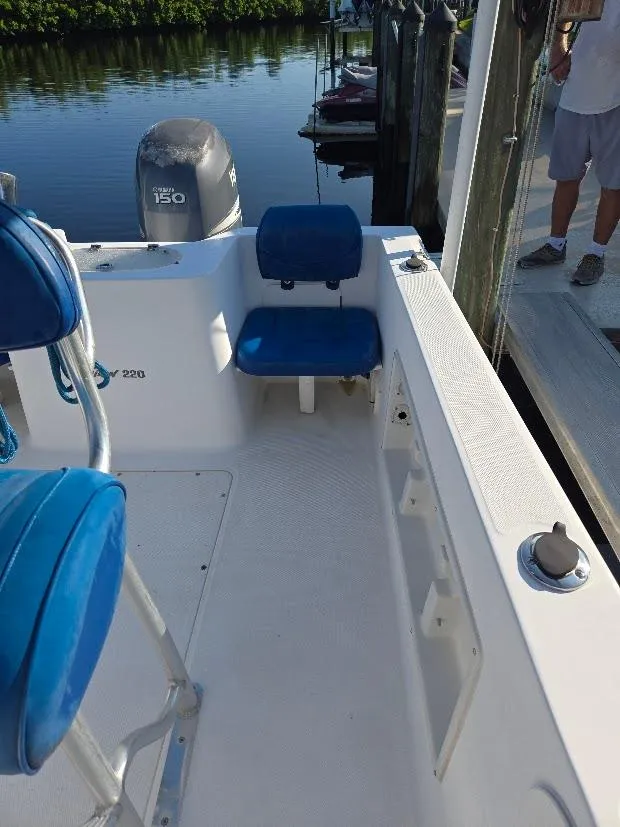 Slide: The Image of 2008 Sea Hunt Triton 220 boat interior with blue seating and Yamaha 150 engine. - 15