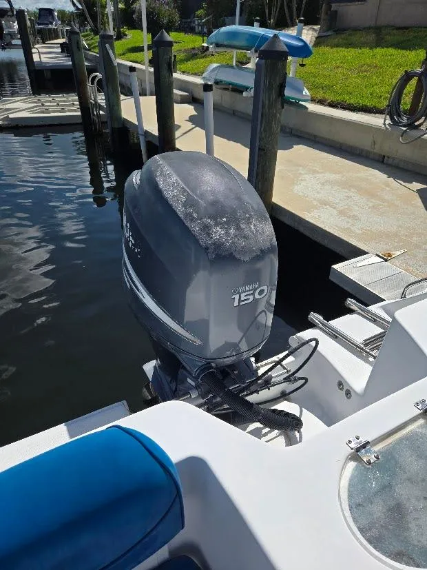 Slide: The Image of 2008 Sea Hunt Triton 220 with Yamaha 150 outboard motor at dock. - 24