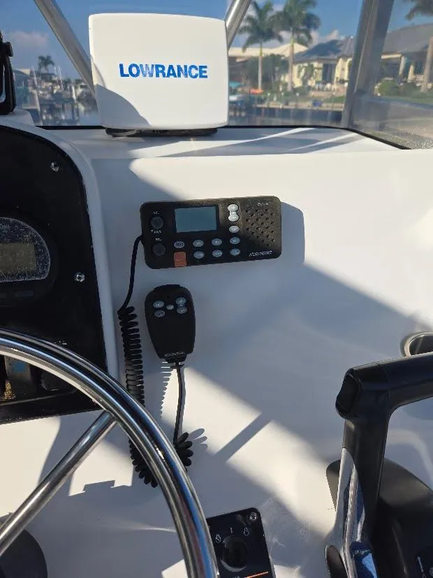 Slide: The Image of 2008 Sea Hunt Triton 220 boat dashboard with Lowrance equipment and radio controls. - 6