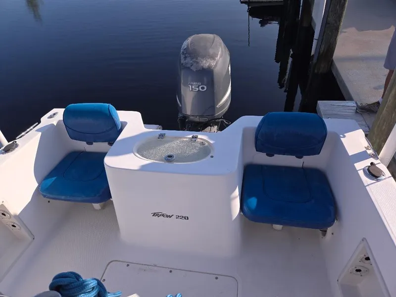 Slide: The Image of 2008 Sea Hunt Triton 220 boat with blue seating and Yamaha 150 outboard motor. - 7