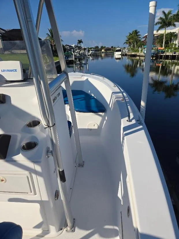 Slide: The Image of 2008 Sea Hunt Triton 220 boat on a calm canal with palm trees. - 9