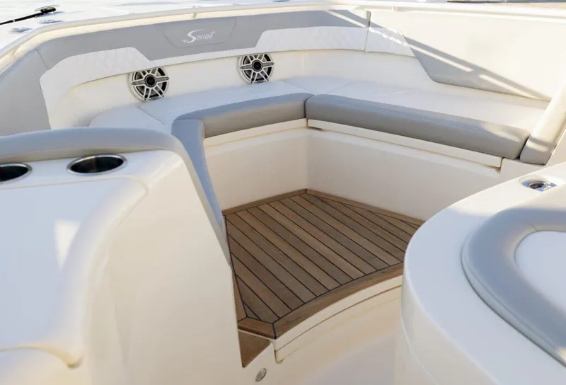Slide: The Image of 2025 Scout 357 LXF boat interior with cushioned seating and teak flooring. - 20