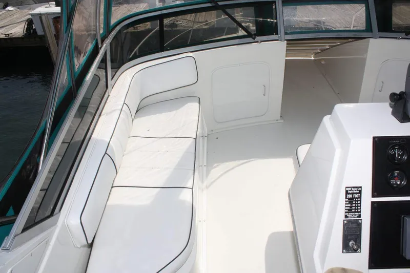 Slide: The Image of 1995 Carver 380 Santego boat interior with white seating and control panel. - 17
