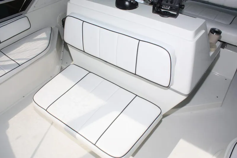 Slide: The Image of 1995 Carver 380 Santego boat interior with white cushioned seating and black trim. - 19