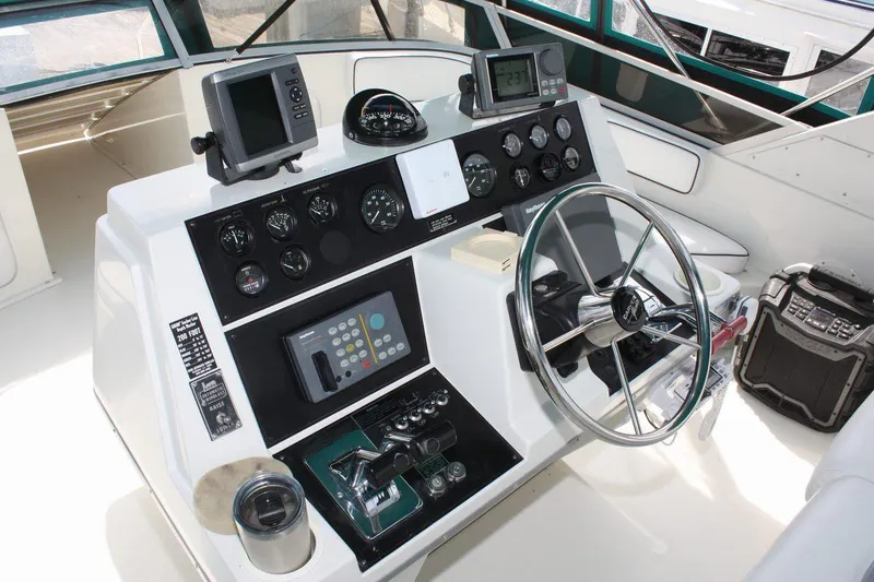 Slide: The Image of 1995 Carver 380 Santego helm with steering wheel, gauges, and navigation equipment. - 21
