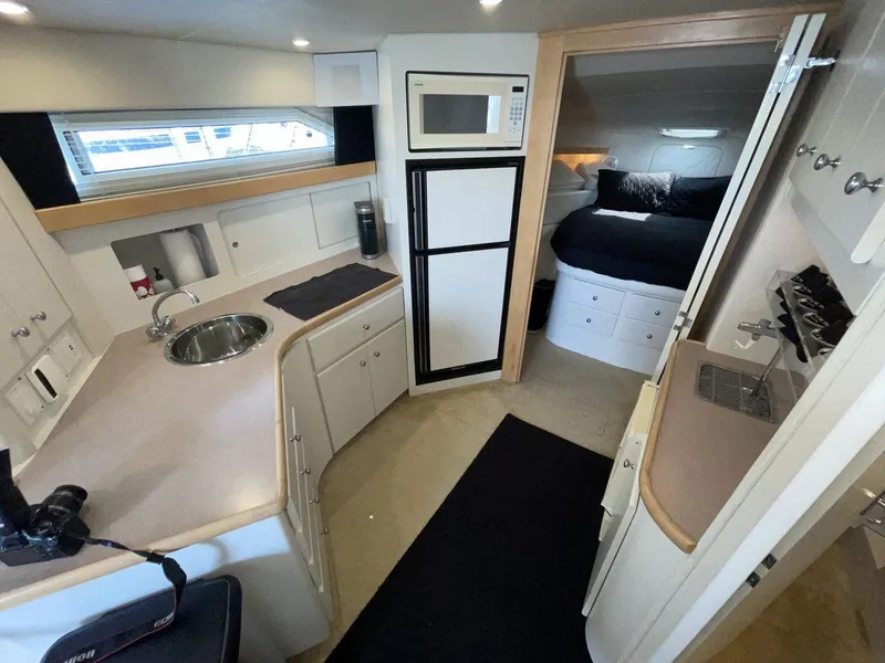 Slide: The Image of Interior of 1995 Carver 380 Santego yacht with kitchen and cozy sleeping area. - 35