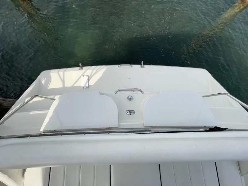 Slide: The Image of 1995 Carver 380 Santego yacht stern view, featuring sleek white deck design. - 5