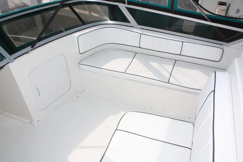 Slide: The Image of 1995 Carver 380 Santego boat interior with white seating and black trim. - 18