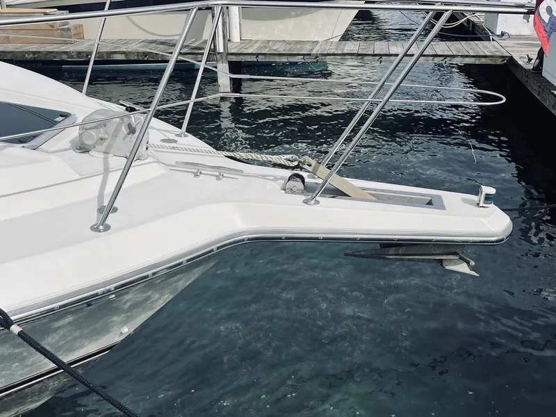 Slide: The Image of 1995 Carver 380 Santego yacht docked at marina, featuring sleek bow design. - 2