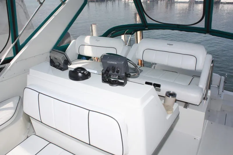 Slide: The Image of 1995 Carver 380 Santego yacht cockpit with white seating and navigation equipment. - 20