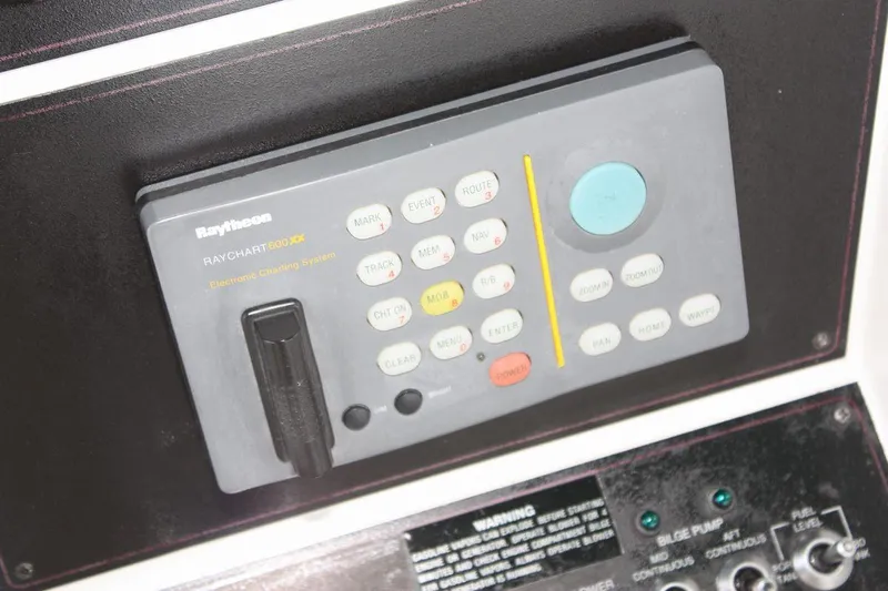 Slide: The Image of Control panel on a 1995 Carver 380 Santego boat, featuring Raytheon navigation system. - 26