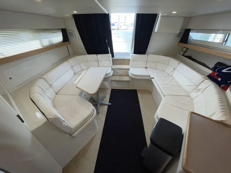 Slide: The Image of Spacious interior of 1995 Carver 380 Santego yacht with white seating and table. - 31