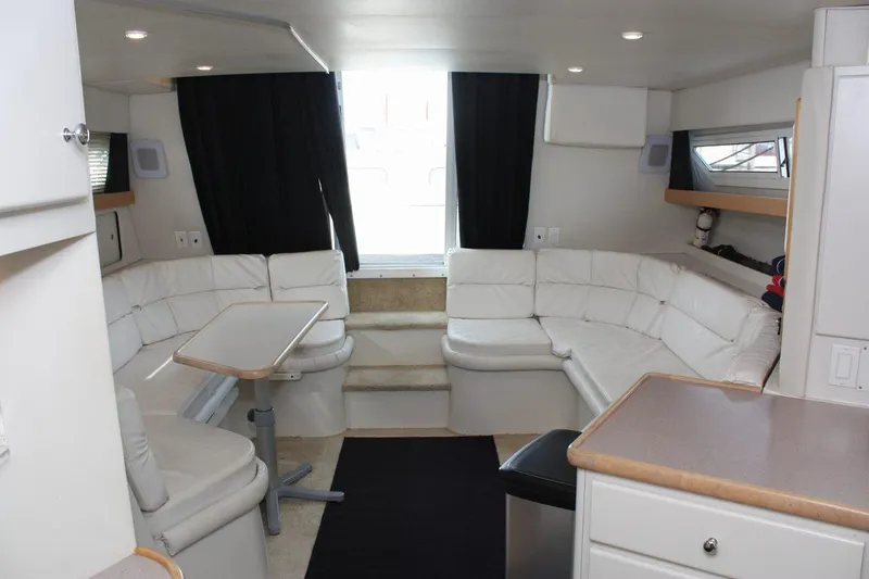 Slide: The Image of Interior of 1995 Carver 380 Santego yacht with white seating and dining area. - 33