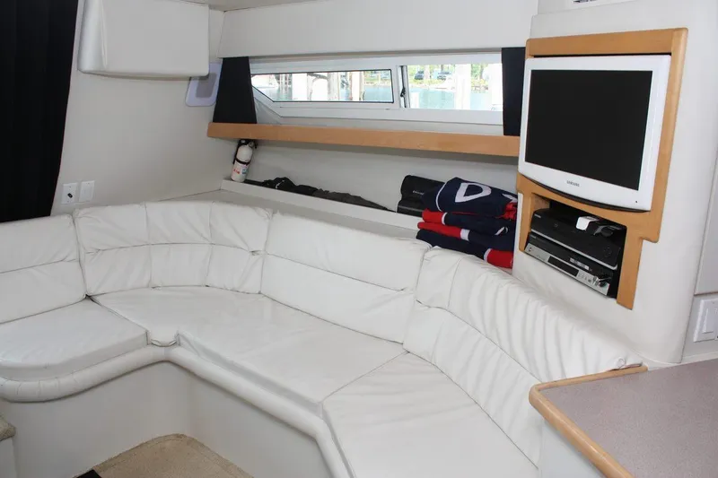 Slide: The Image of Interior of 1995 Carver 380 Santego yacht with white leather seating and mounted TV. - 34