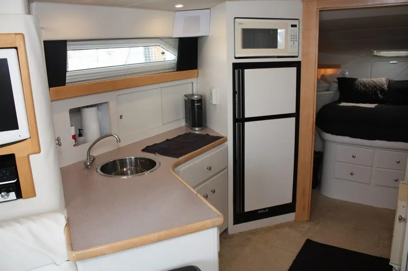 Slide: The Image of Interior of 1995 Carver 380 Santego yacht with kitchenette and cozy sleeping area. - 37