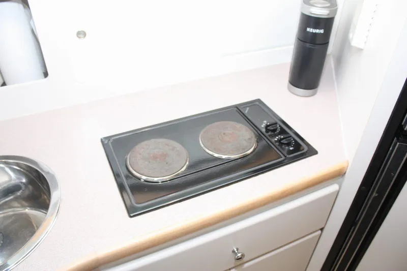 Slide: The Image of 1995 Carver 380 Santego yacht kitchen with stove and sink. - 38