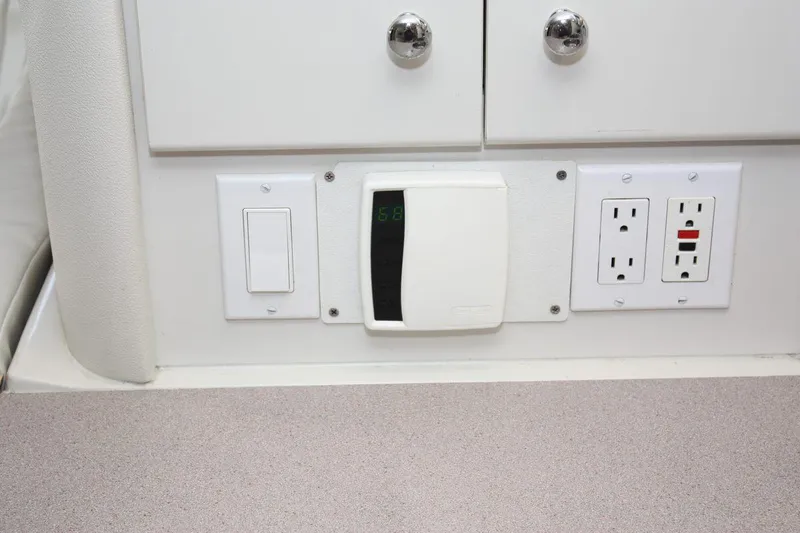 Slide: The Image of 1995 Carver 380 Santego interior with thermostat, light switch, and power outlets. - 40