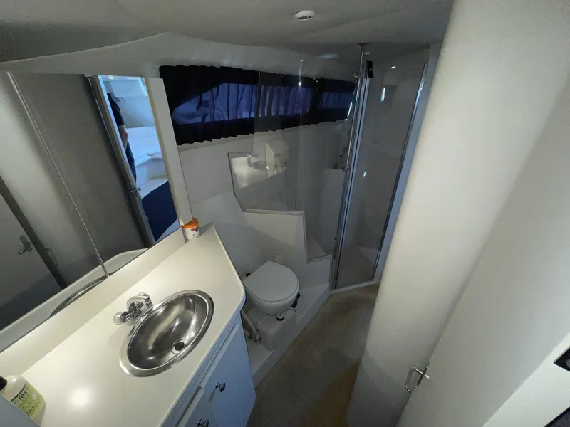 Slide: The Image of 1995 Carver 380 Santego yacht bathroom with sink, toilet, and shower. - 46