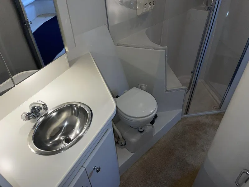 Slide: The Image of 1995 Carver 380 Santego yacht bathroom with sink, toilet, and shower. - 49