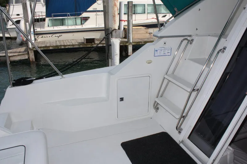 Slide: The Image of 1995 Carver 380 Santego yacht deck with ladder and marina view. - 9
