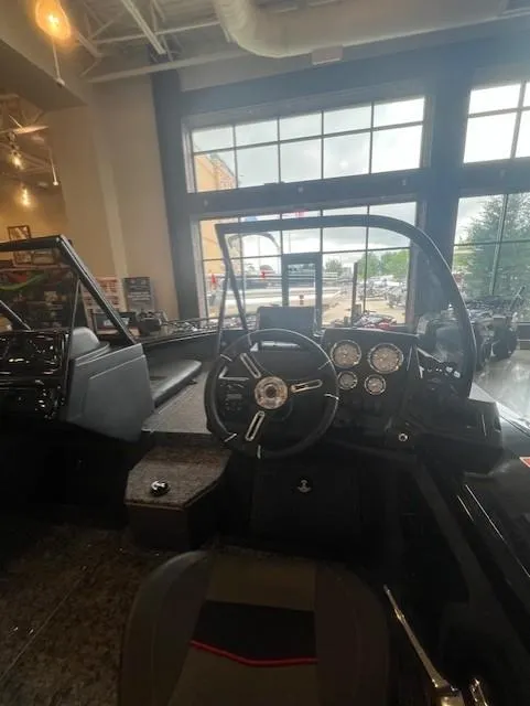 Slide: The Image of 2025 Tracker Targa V-19 Combo boat interior with steering wheel and dashboard. - 5