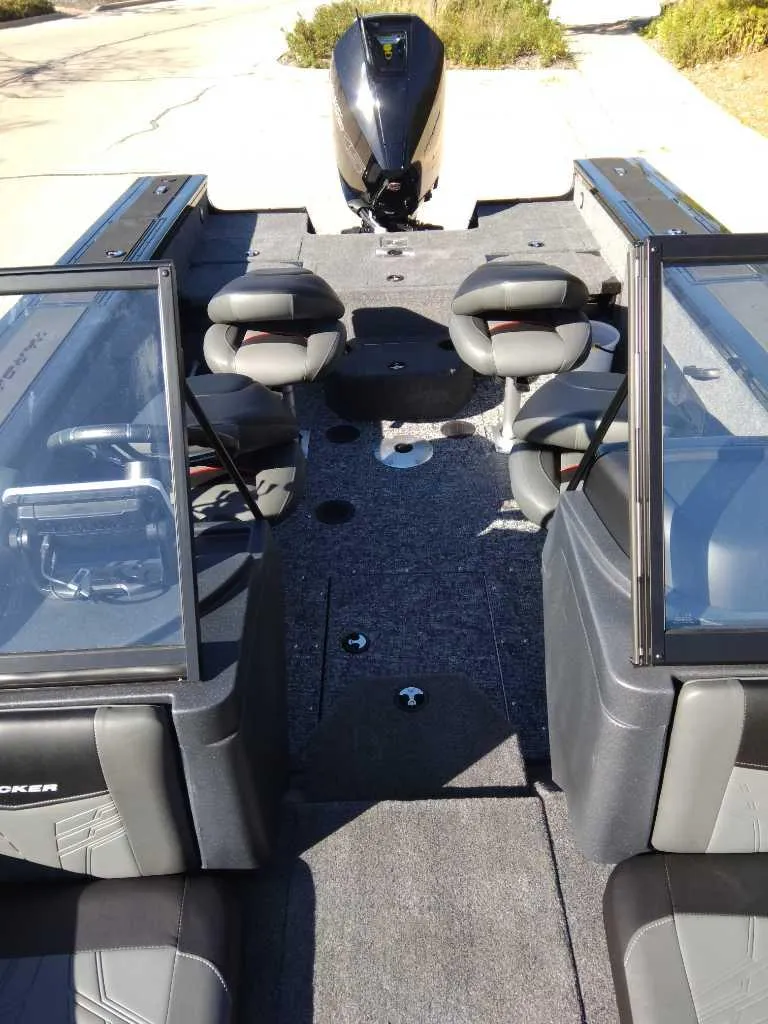Slide: The Image of 2025 Tracker Targa V-18 Combo boat interior with seating and motor. - 2