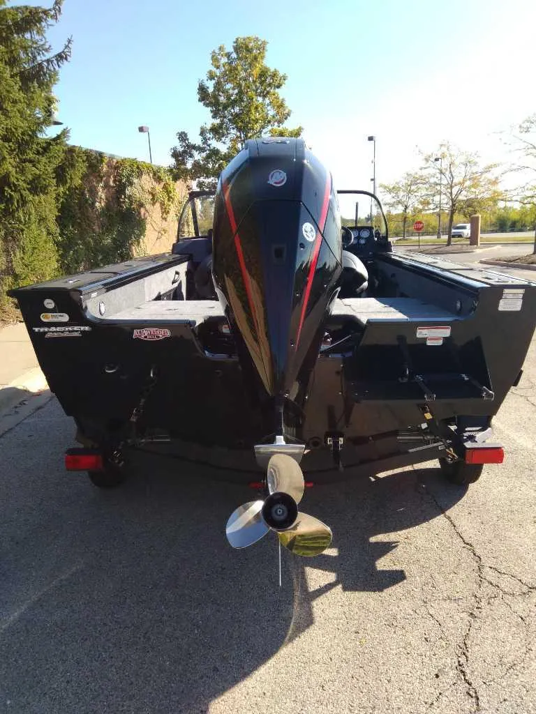 Slide: The Image of 2025 Tracker Targa V-18 Combo boat, rear view, parked outdoors. - 4