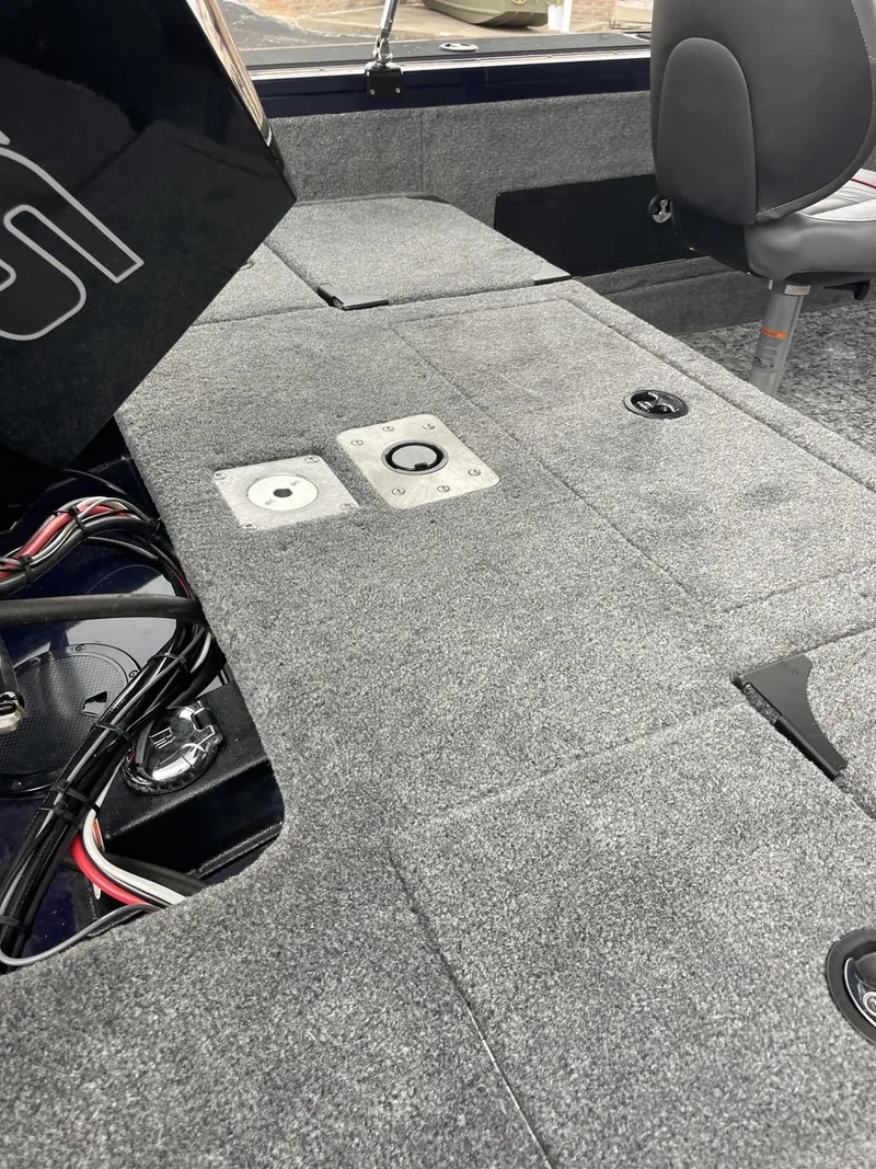 Slide: The Image of 2025 Tracker Targa V-18 Combo boat interior with gray carpeted deck and seating. - 12