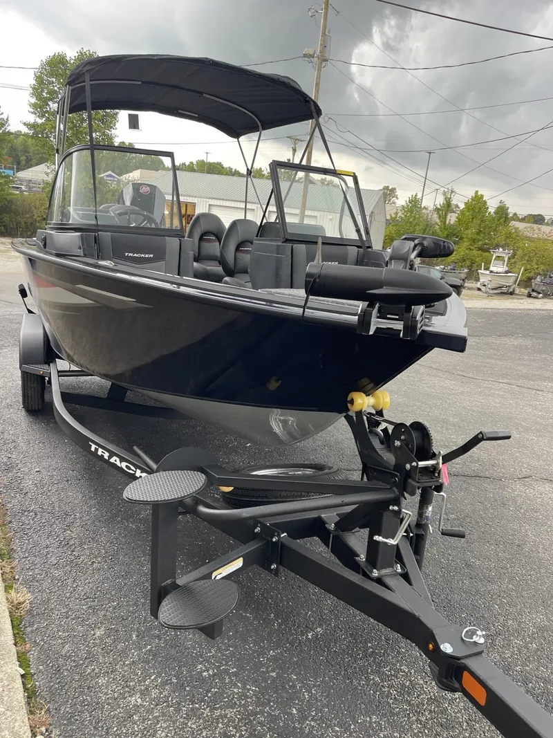 Slide: The Image of 2025 Tracker Targa V-18 Combo boat on trailer, parked outdoors. - 3
