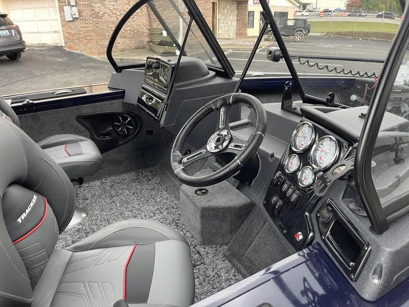 Slide: The Image of 2025 Tracker Targa V-18 Combo boat interior with steering wheel and dashboard controls. - 6