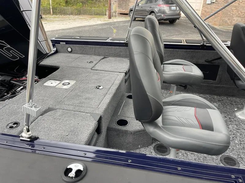 Slide: The Image of 2025 Tracker Targa V-18 Combo boat interior with gray seating and carpeted deck. - 8