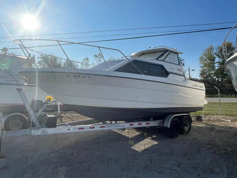 Slide: The Image of 2001 Bayliner 2452 Ciera Express boat on trailer under sunny sky. - 3