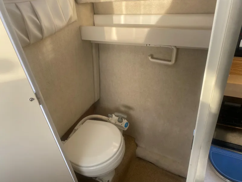 Slide: The Image of 2001 Bayliner 2452 Ciera Express boat bathroom interior with compact toilet. - 7