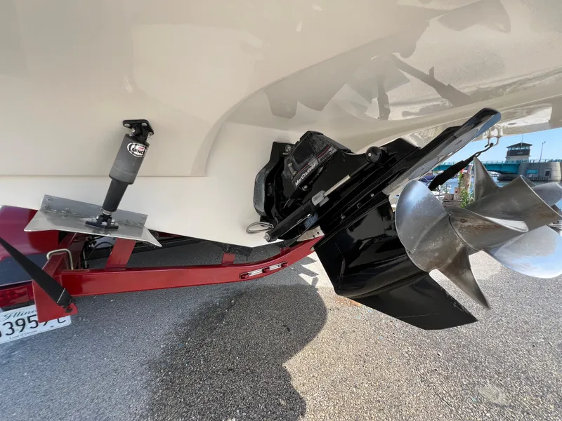 Slide: The Image of 2009 Rinker 246 Captiva Bowrider's propeller and stern drive on a trailer. - 12