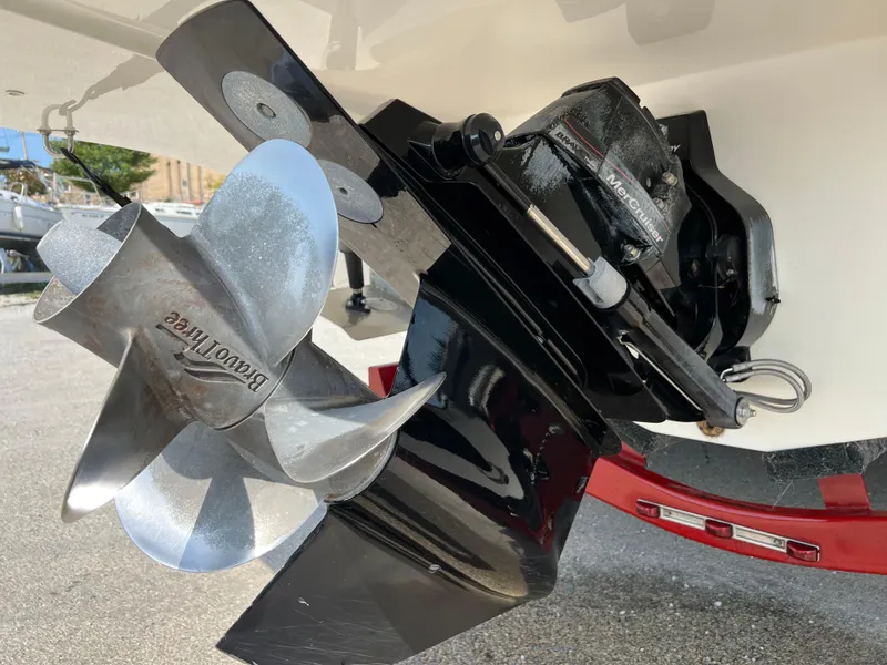 Slide: The Image of 2009 Rinker 246 Captiva Bowrider boat propeller and outdrive close-up. - 14
